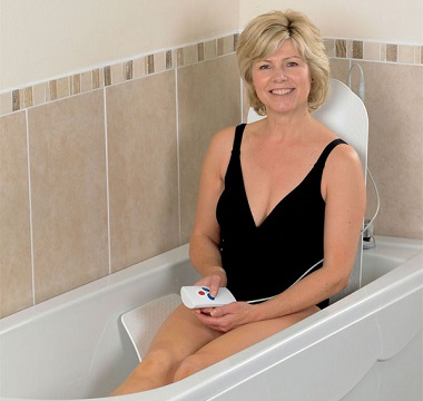 Lady sat in bath using bathlift